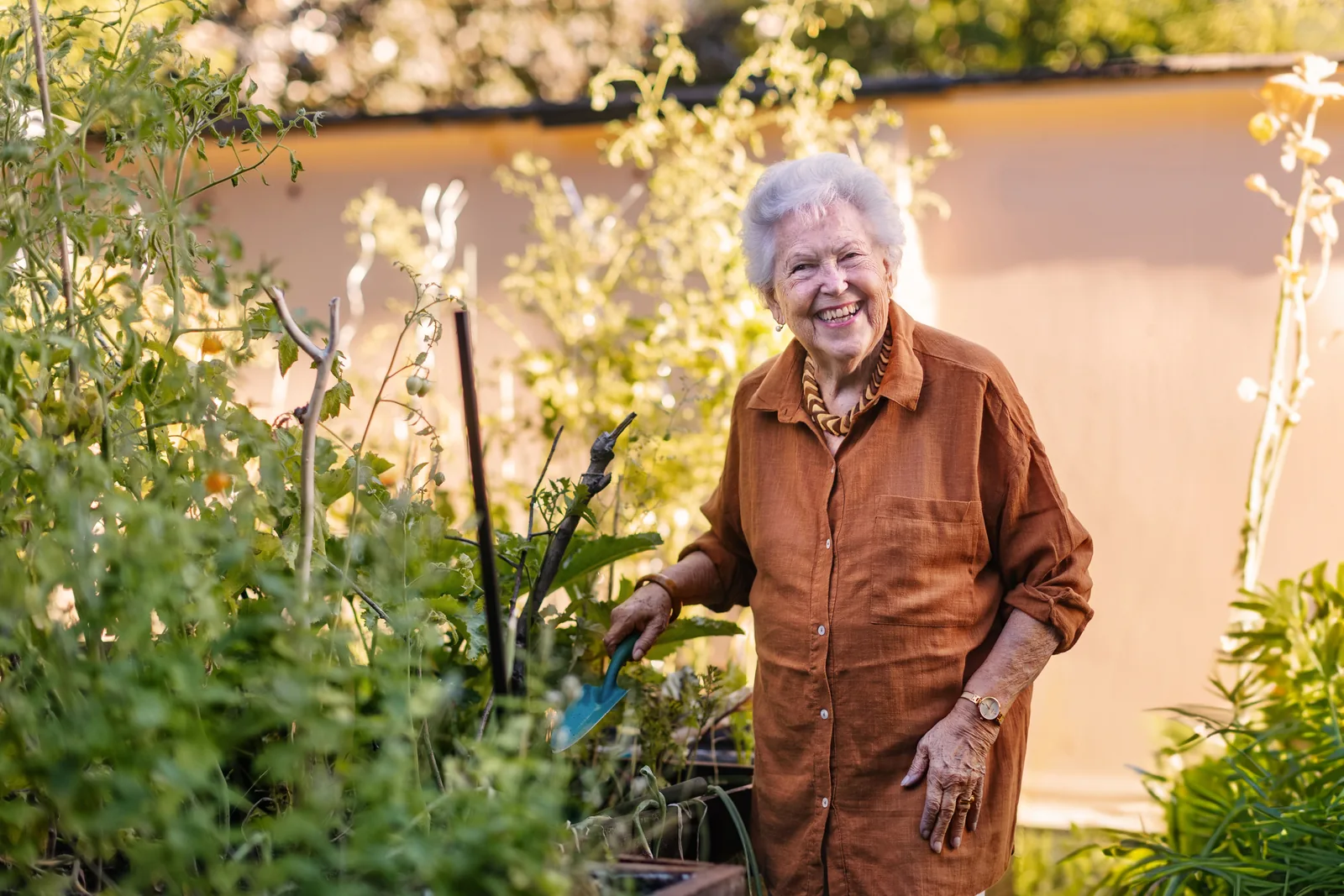 Oudere vrouw in de tuin van mantelzorgwoning