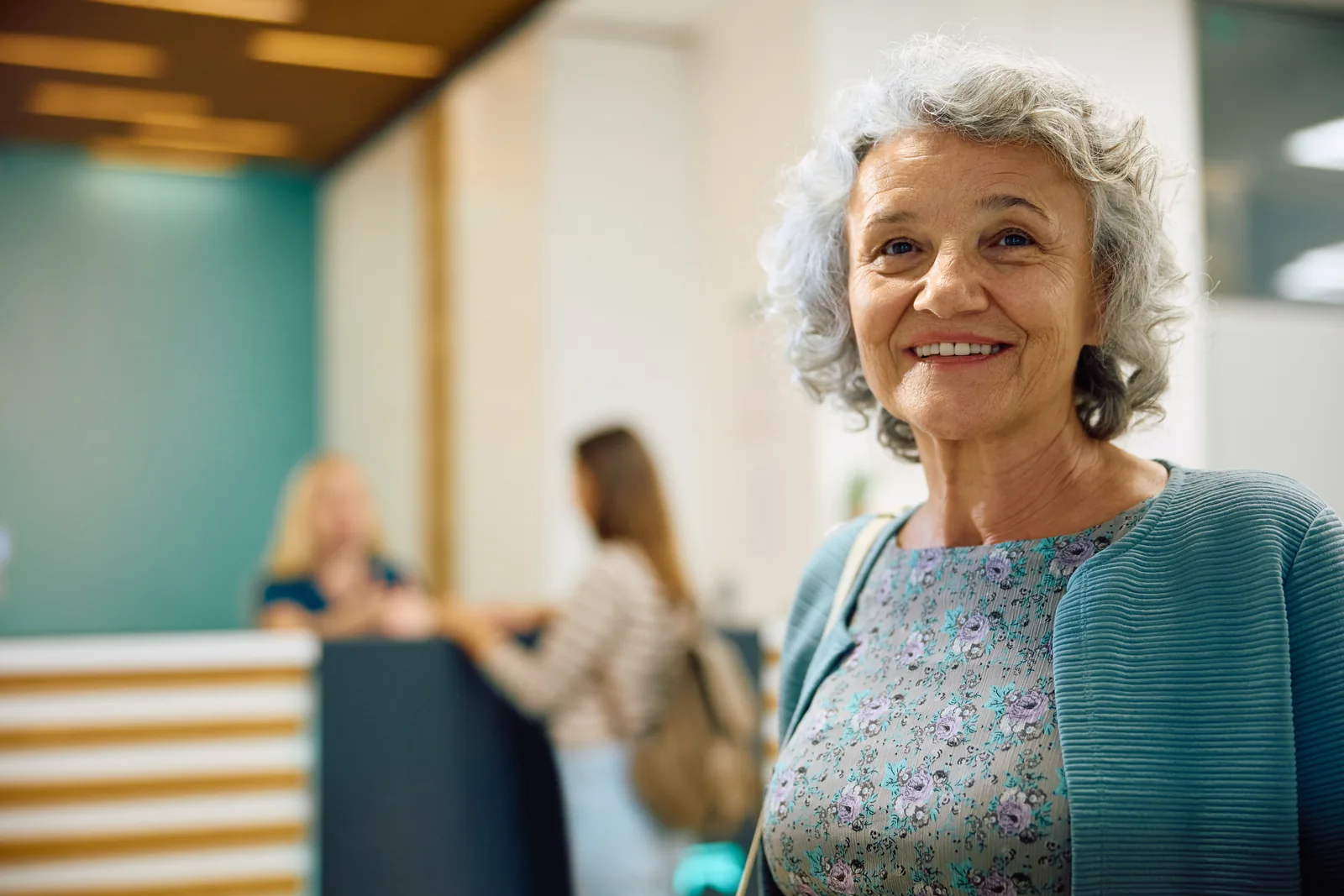 Oudere vrouw in de gang van een zorglocatie
